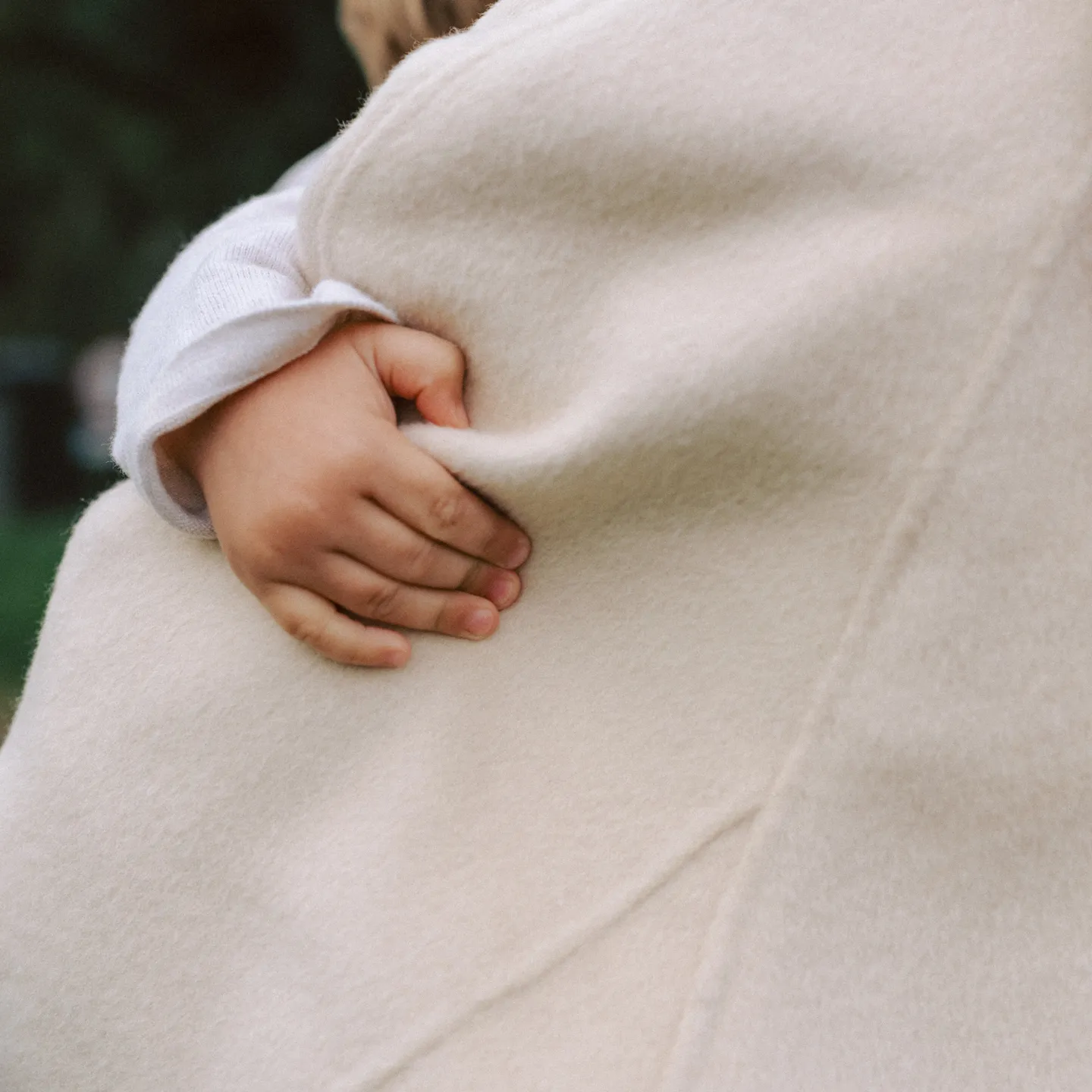 Kids hand holding on to a jacket
