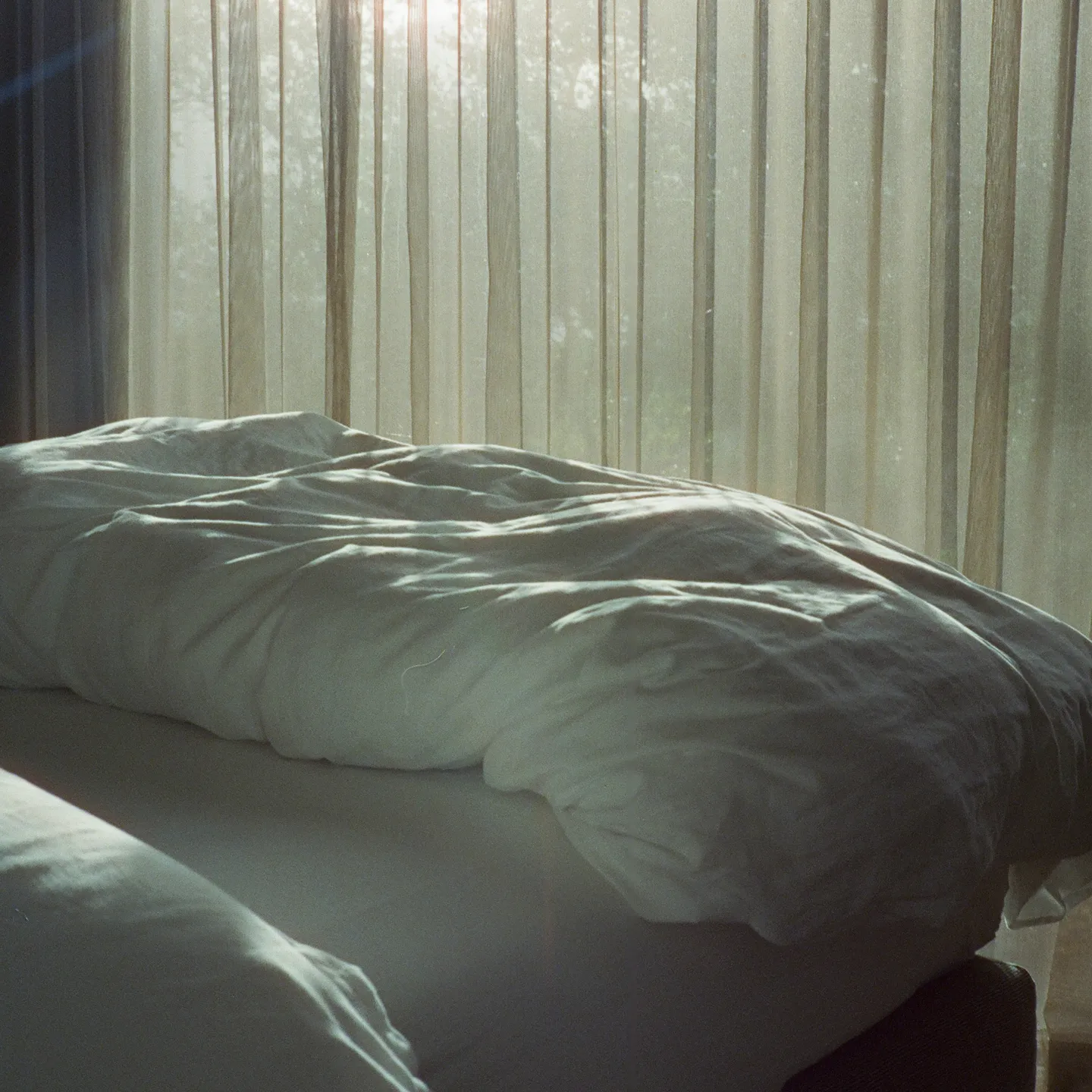 Bed in Blick apartment with morning light