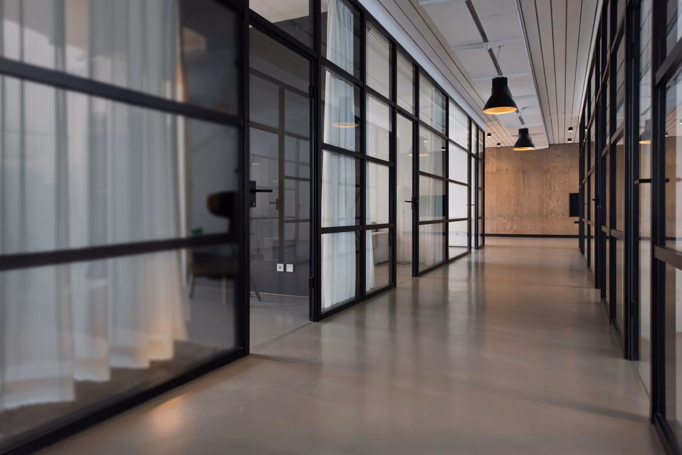 a spaceous office with glass windows
