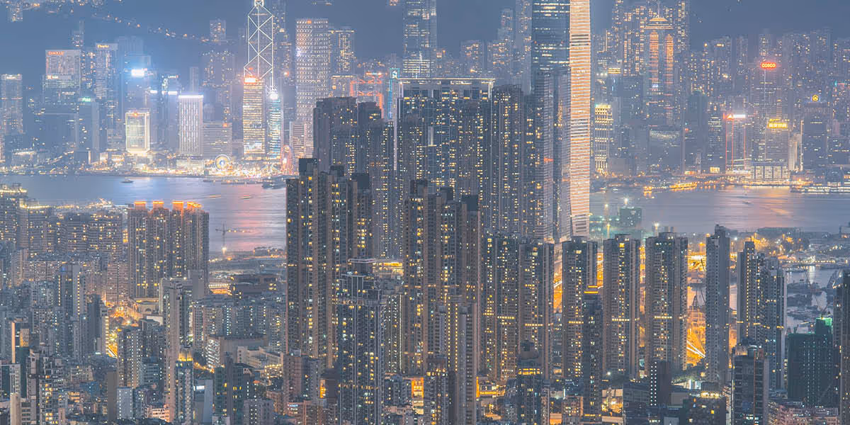 A city at dusk where the buildings are lit up 