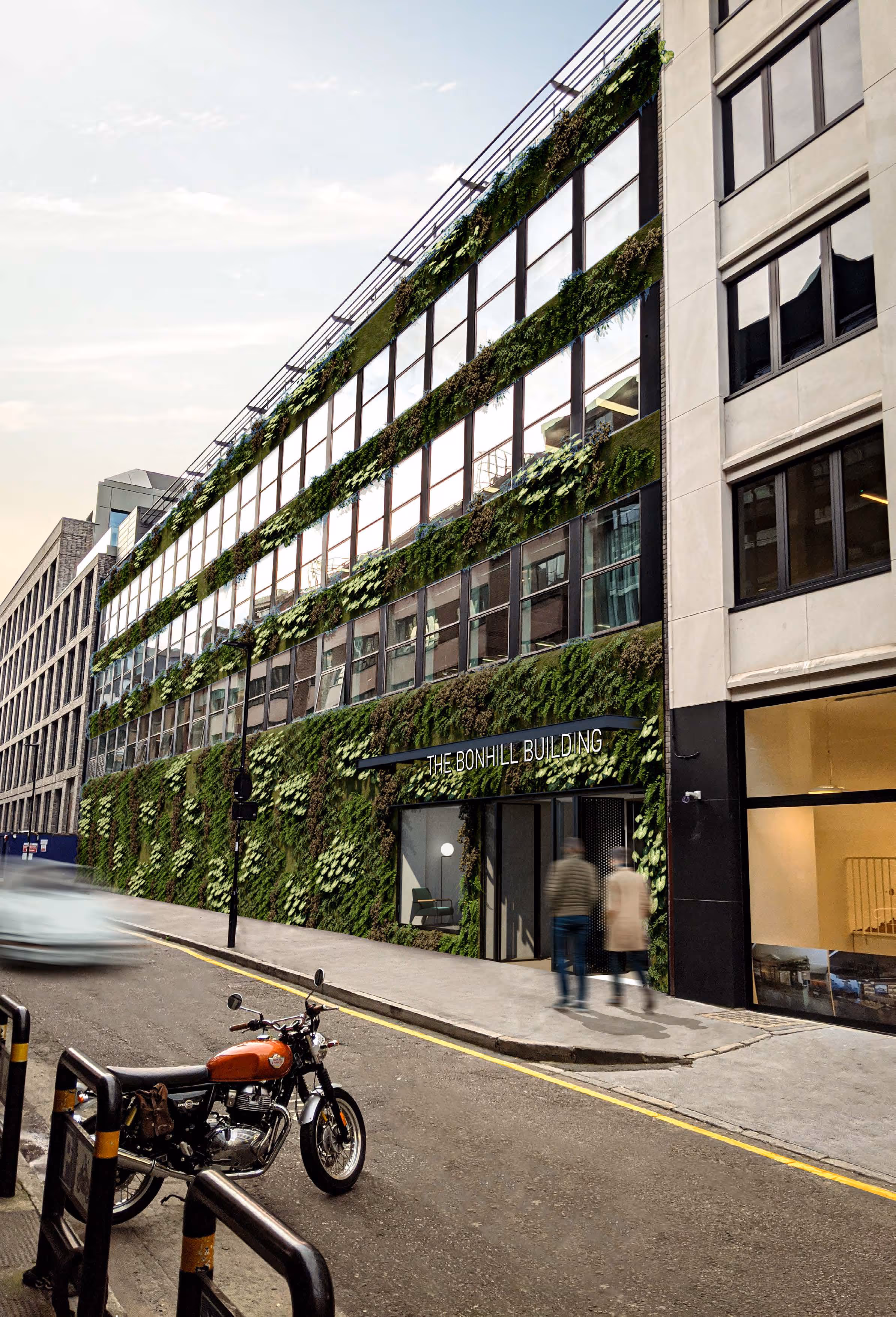 Green-covered Bonhill Building with motorcycle parked on urban street