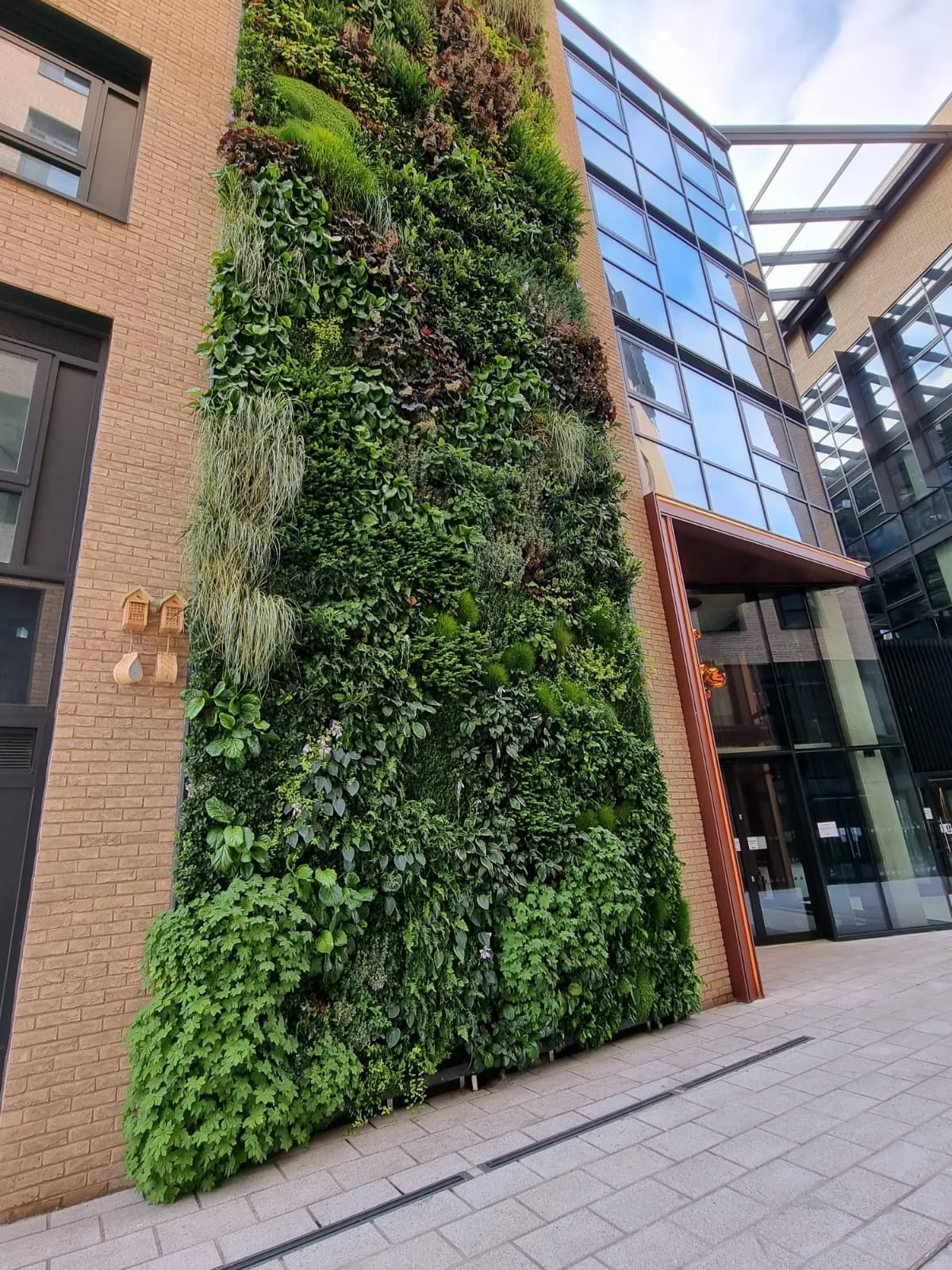 Exterior of The Distillery, Glassfields, with a large living wall 