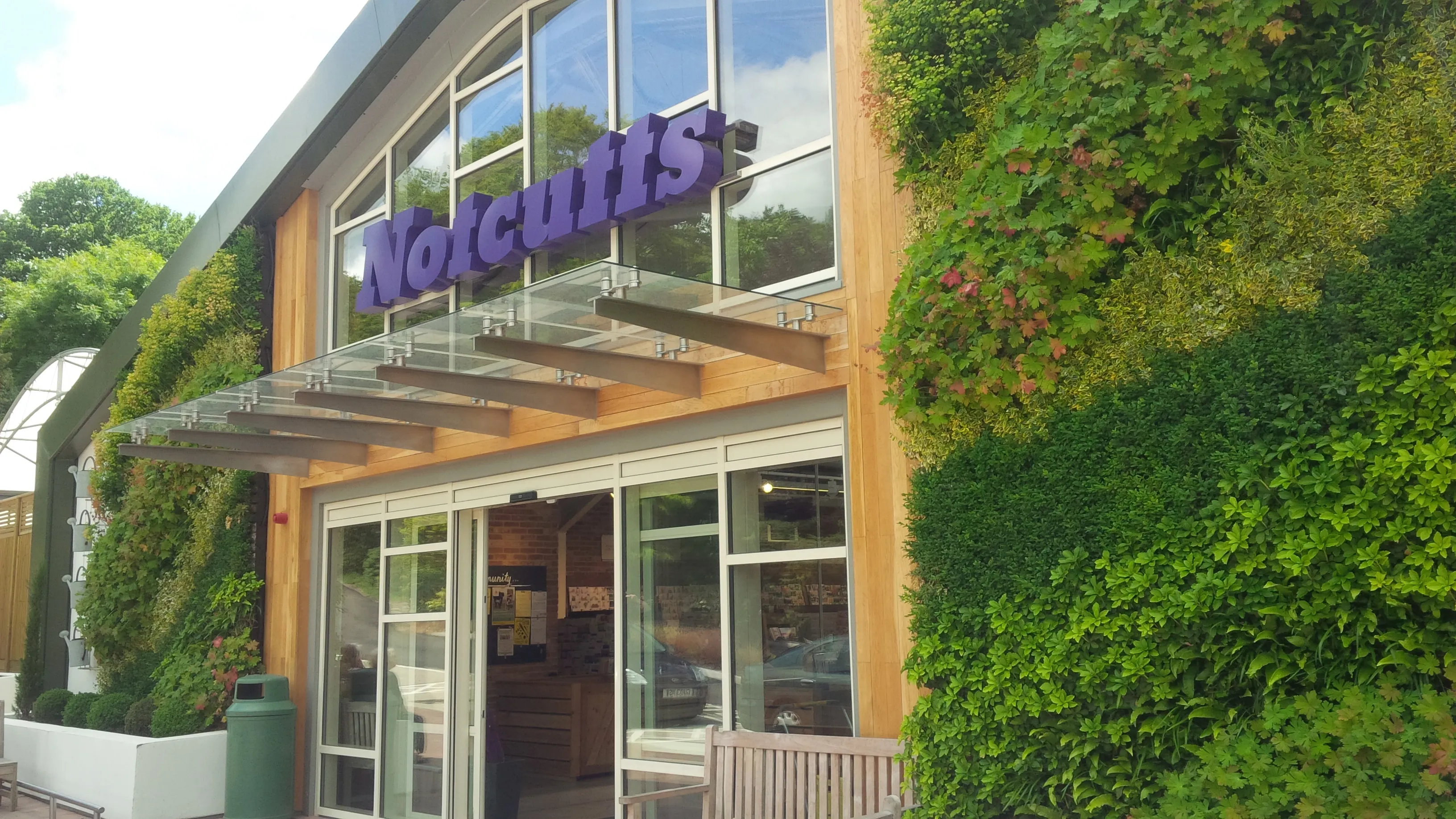 Front exterior of Notcutts, with two large living walls either side of the entrance