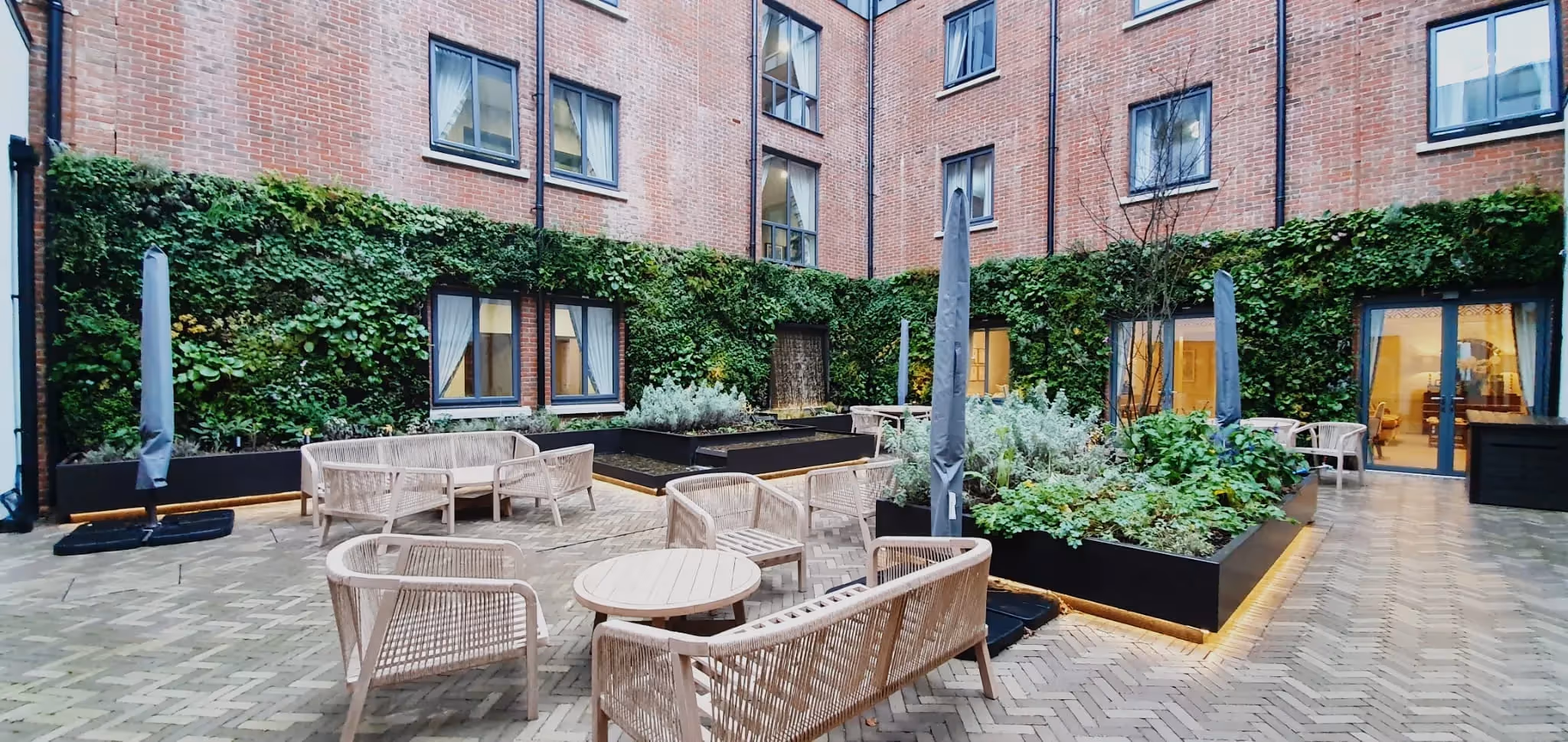 Eden Grange care home courtyard, with walls covered in living walls 