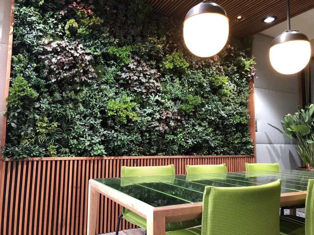 Interior of Residential Loggia, showing a dining table with an interior living wall behind it