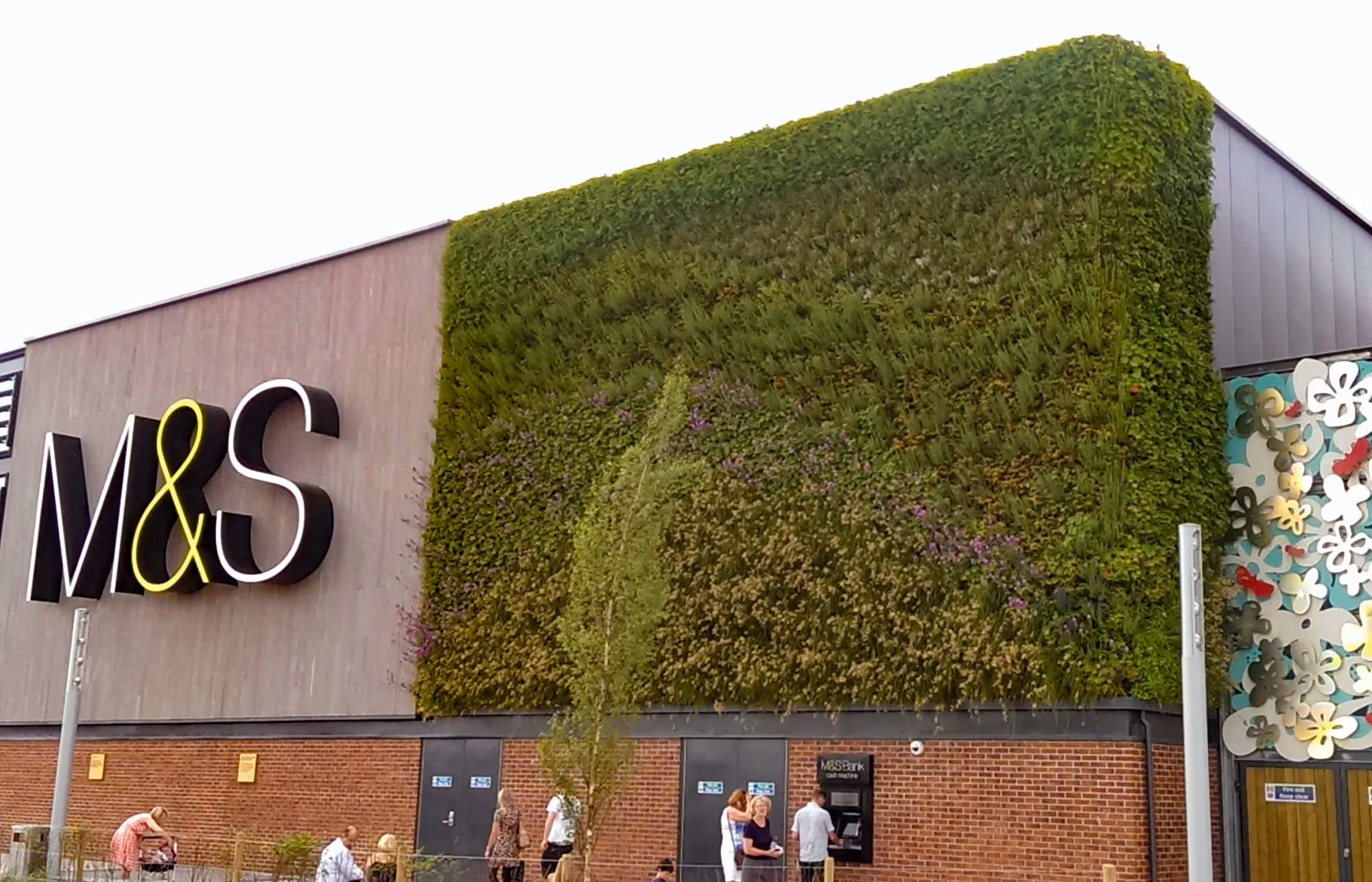 Front exterior of M&S Monks Cross, with a large living wall 