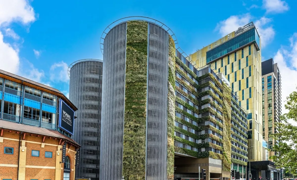 Large building next to Woking shopping centre, featuring strips of living wall running horizontally and vertically