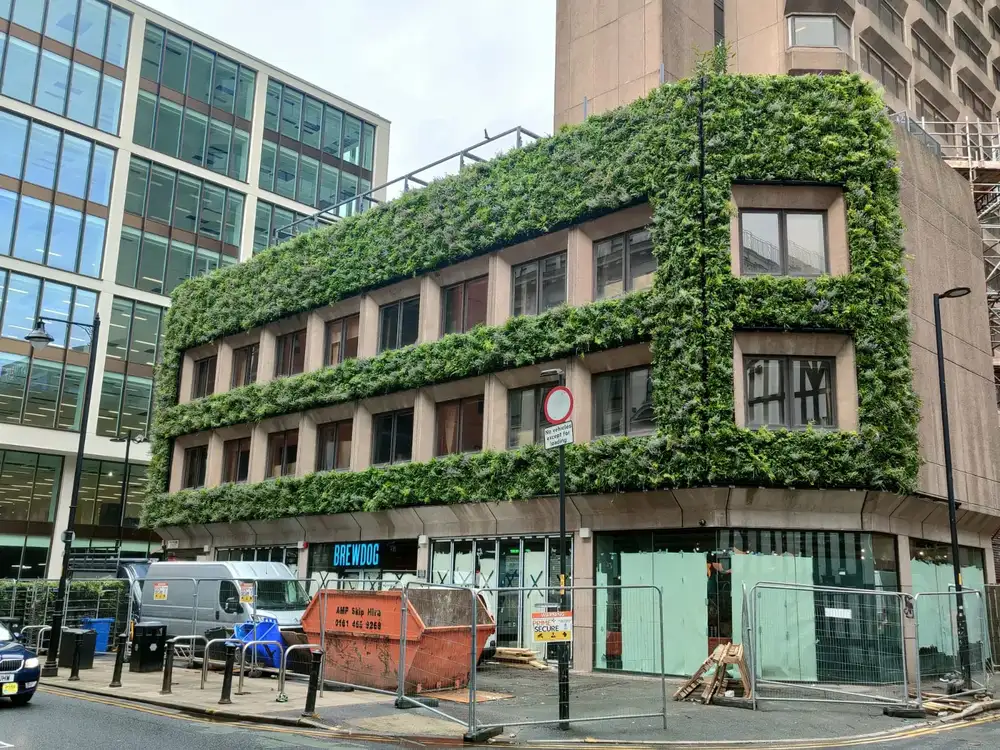 Exterior of BrewDog Hotel in Manchester under construction, with a living wall 