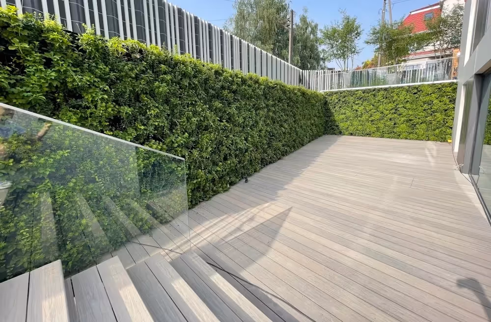 Exterior living wall wrapped around the walls of a garden in a private residence in Warsaw, Poland