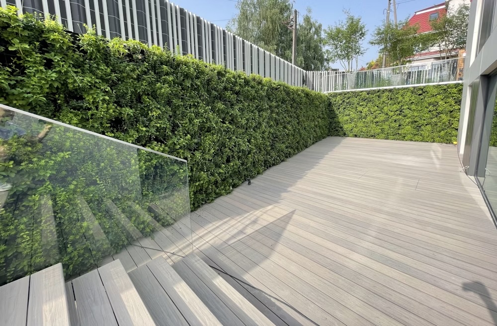 Exterior living wall wrapped around the walls of a garden in a private residence in Warsaw, Poland