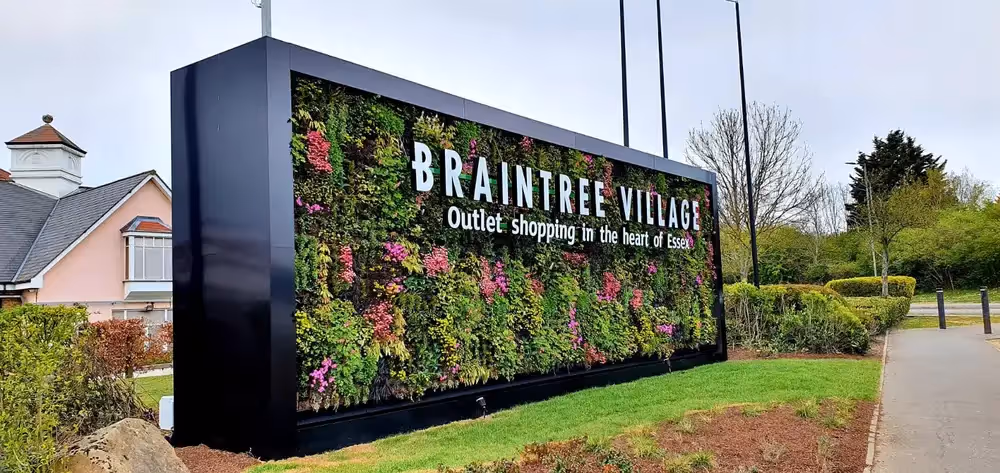 The larger of the two living walls is at the entrance to the village, encased in a huge black frame which provides a stunning contrast to the bright pops of pink.