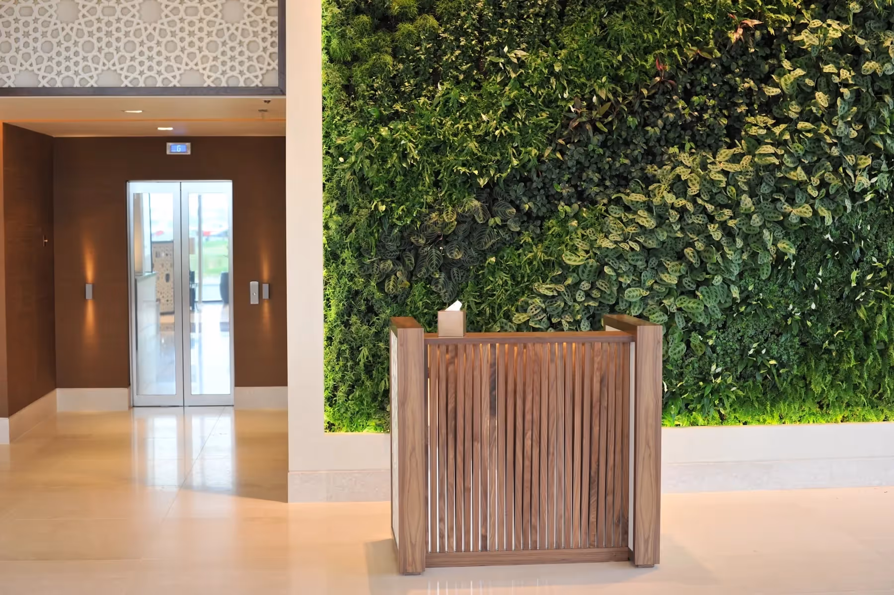 The brief from the client was to create a six star hotel reception, an atmosphere of richness and structural drama that our full-height living wall communicates. 