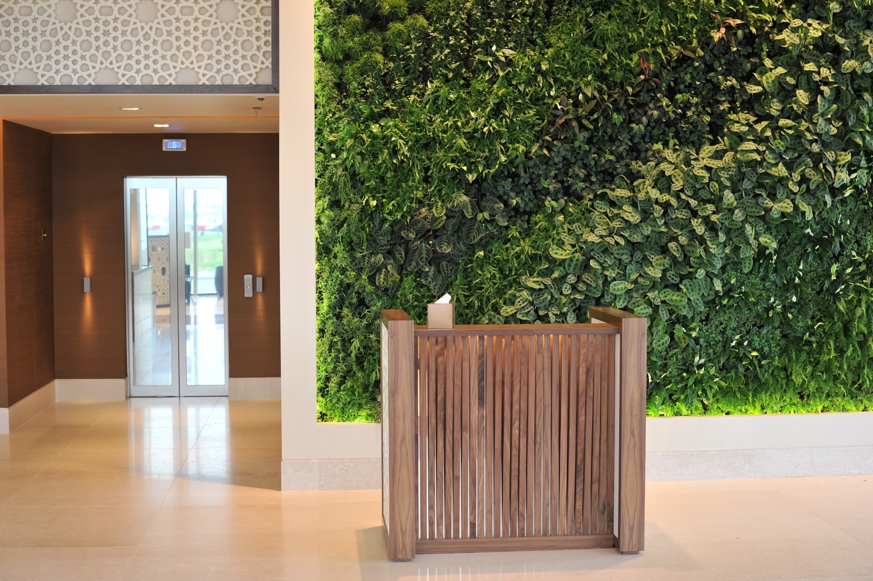 The brief from the client was to create a six star hotel reception, an atmosphere of richness and structural drama that our full-height living wall communicates. 