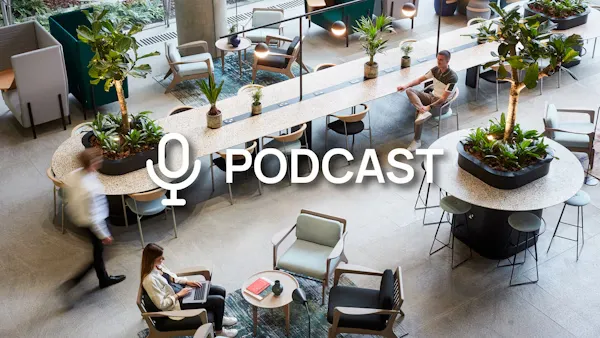 An office background with plants. Text in the foreground saying "Podcast"