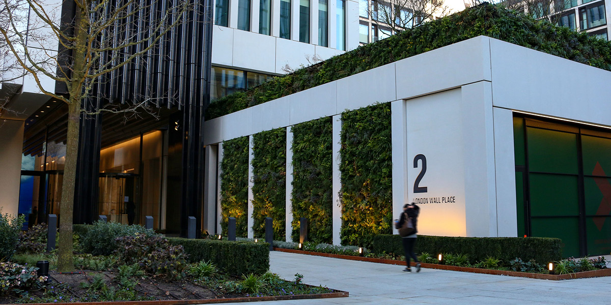 Living wall at modern building entrance with number 2 sign