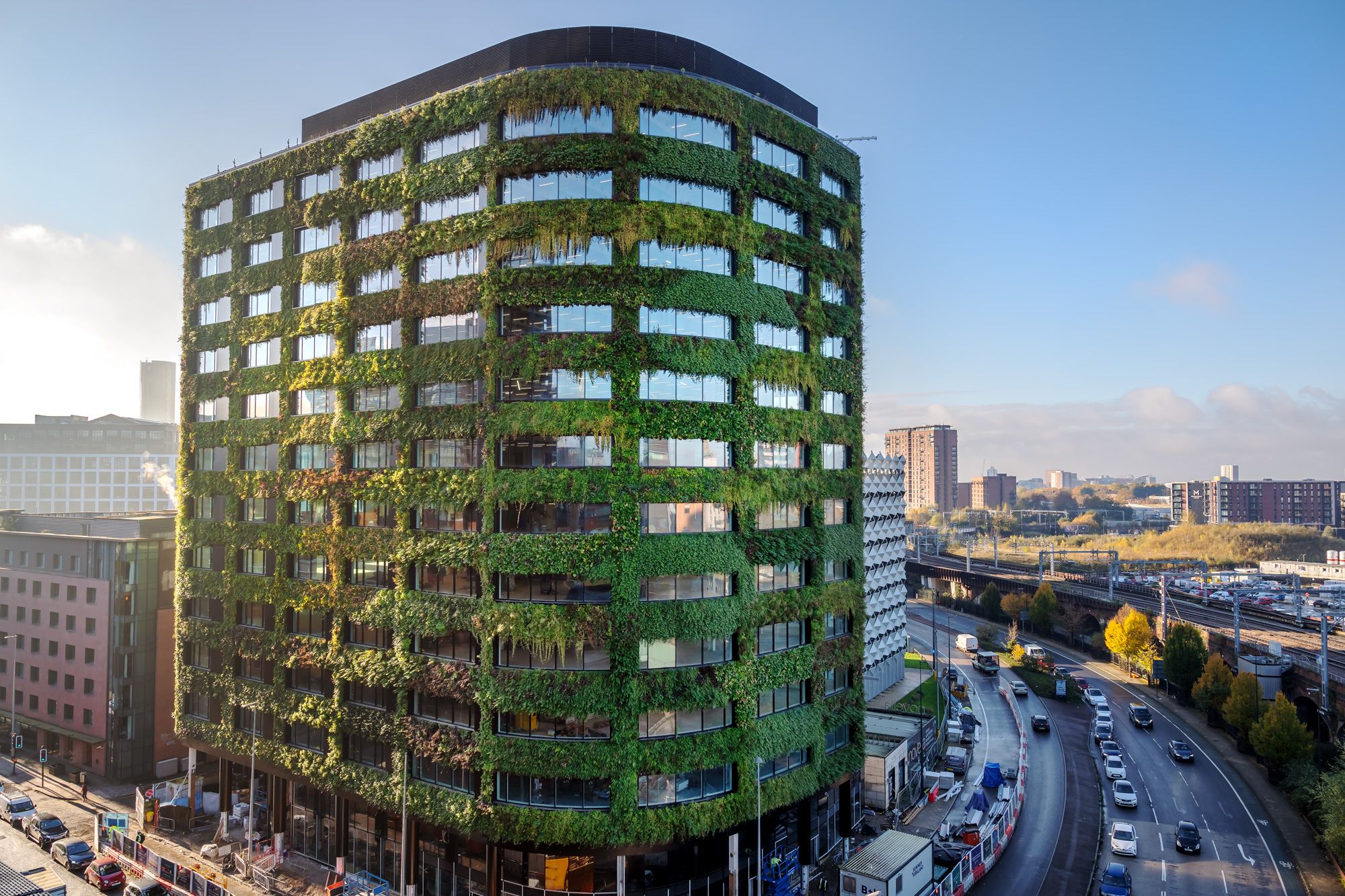 Living wall transforms modern urban office building with lush green vegetation