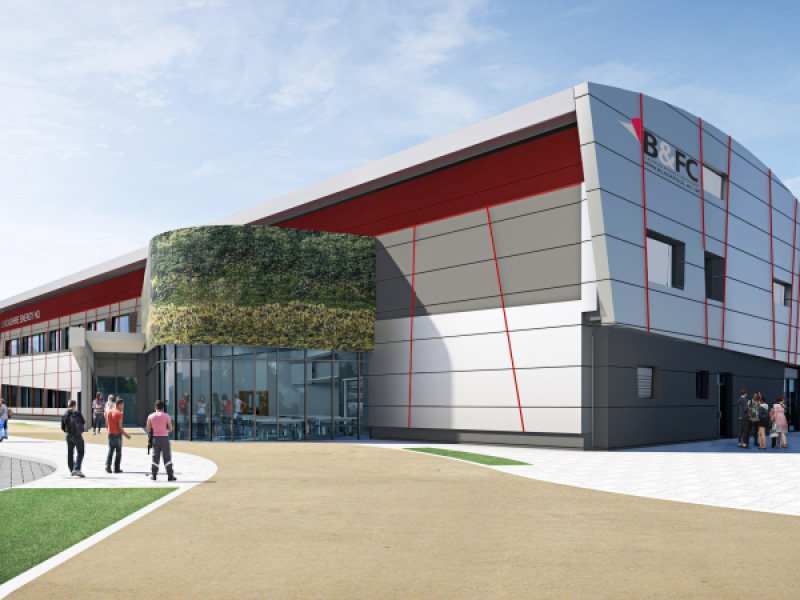 Modern BFCL building with green wall, people walking near entrance
