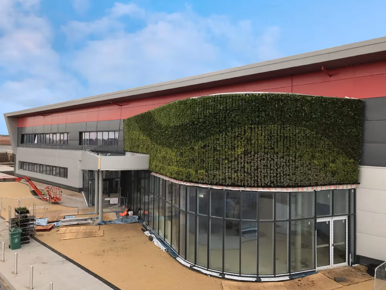 Modern building with green living wall and curved glass exterior