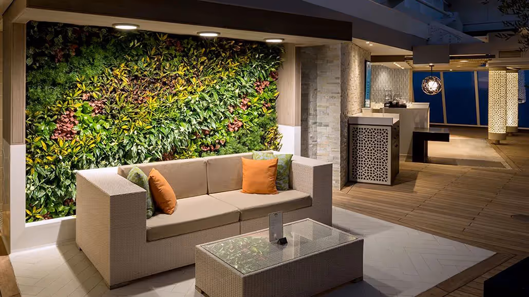Modern lounge with living green wall, white sofa, and outdoor deck