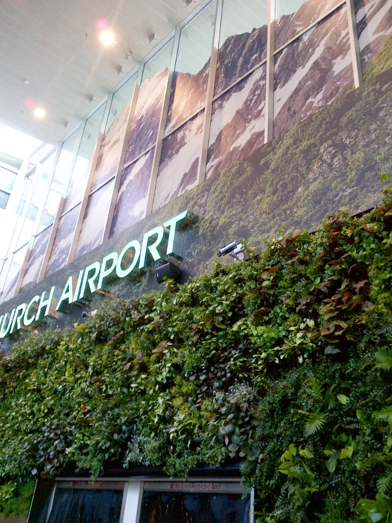 Lush green wall with mountain landscape at Zurich Airport entrance