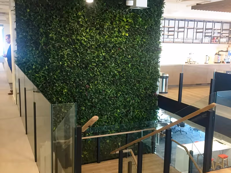 Green living wall divides modern interior space with lush vertical garden