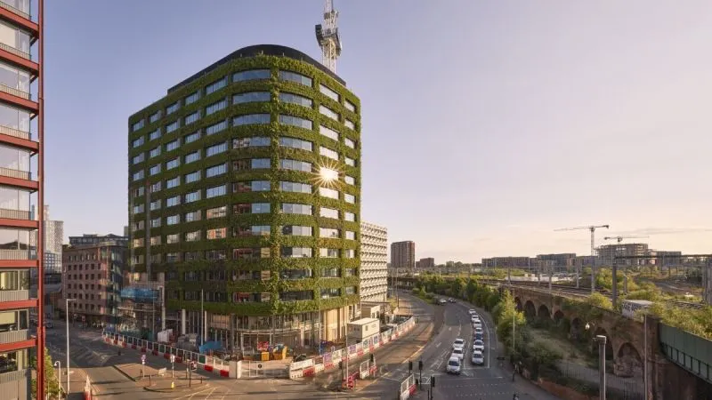 Green vertical garden skyscraper with living walls in urban cityscape