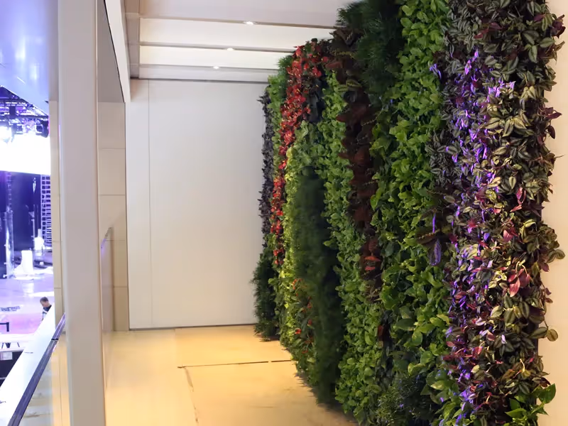 Vertical garden wall with green, red, and purple leafy plants