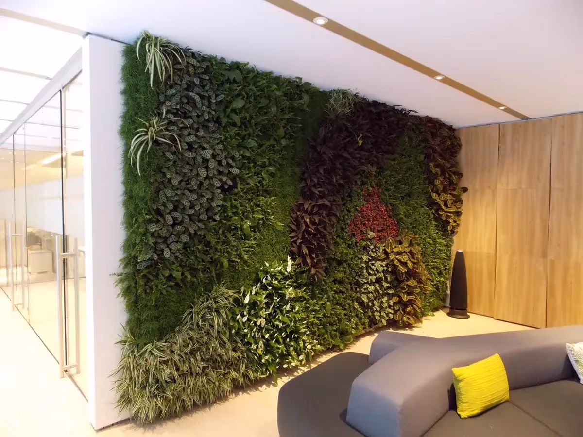 Green living wall with diverse plants in modern minimalist interior