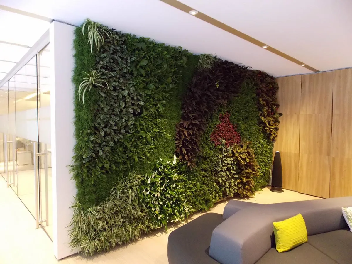 Green living wall with diverse plants in modern minimalist interior