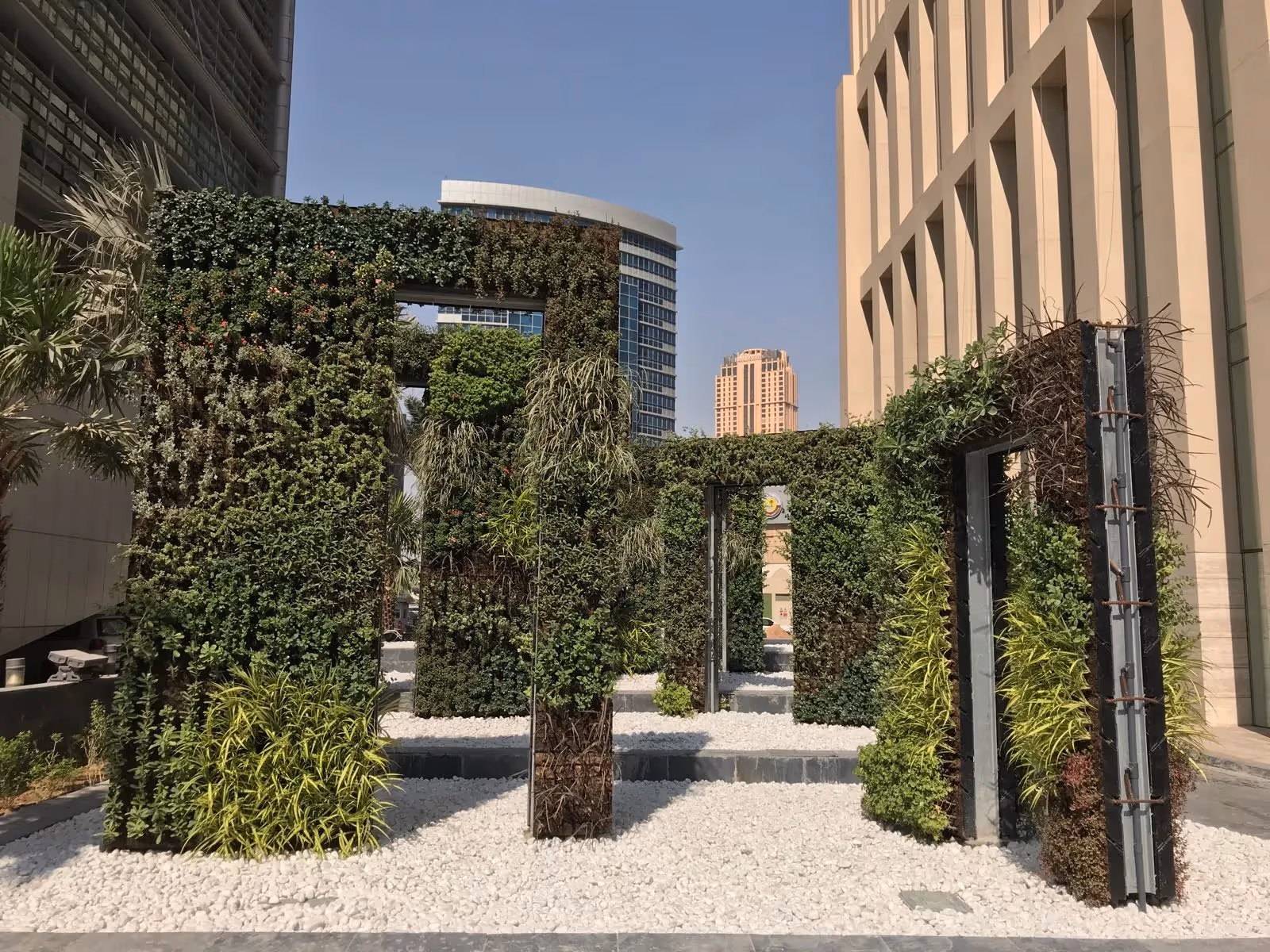 Arches of living walls in a courtyard space