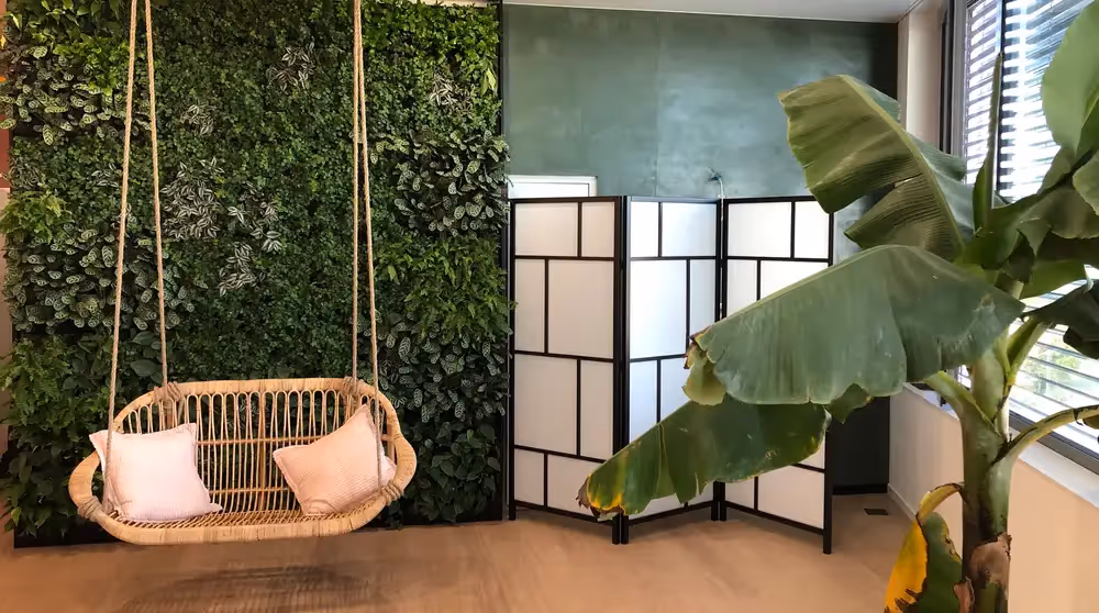 Reception area of HD Geneva Clinic, with a living wall behind the seating area