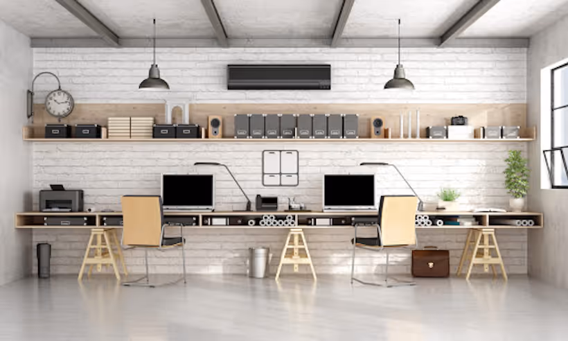 Minimalist workspace with computers, shelves, and white brick wall