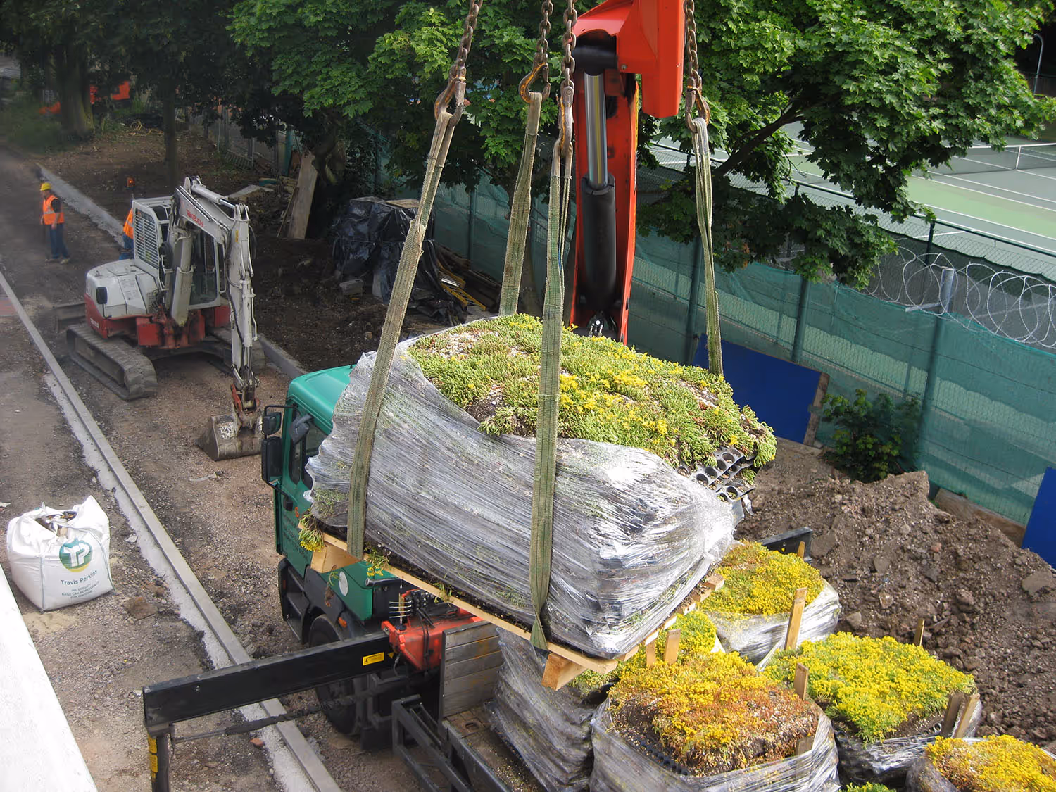 Living wall panels being transported and installed at construction site