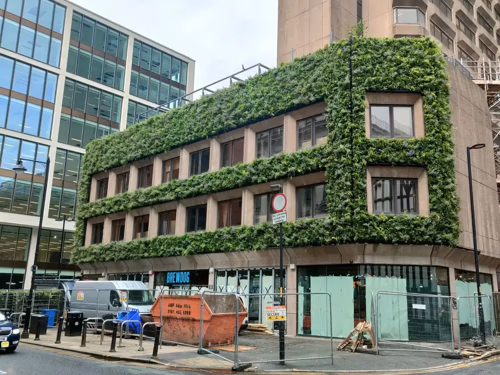 Exterior of BrewDog Hotel in Manchester under construction, with a living wall