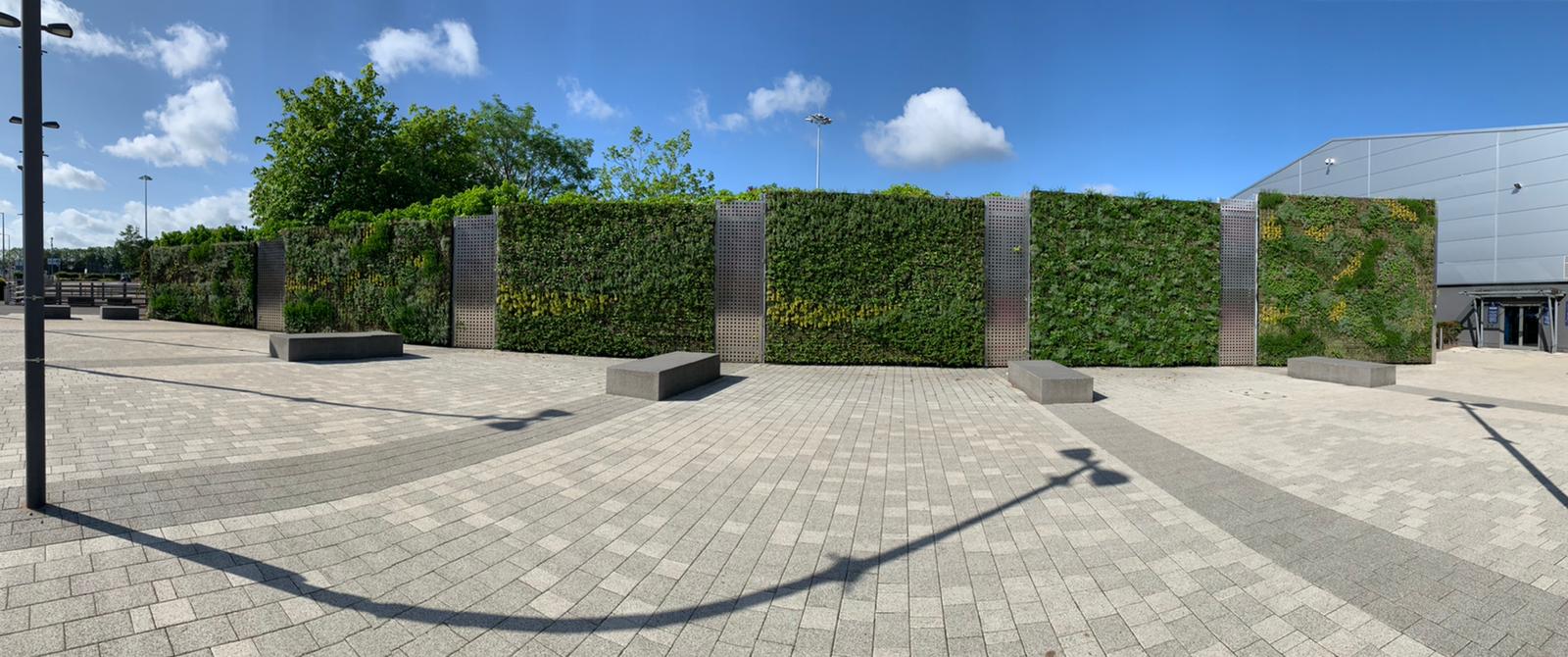 The NEC exterior with a large living wall