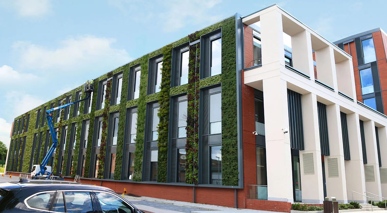 University of Leicester outdoor living wall with a cherry picker maintaining the outside