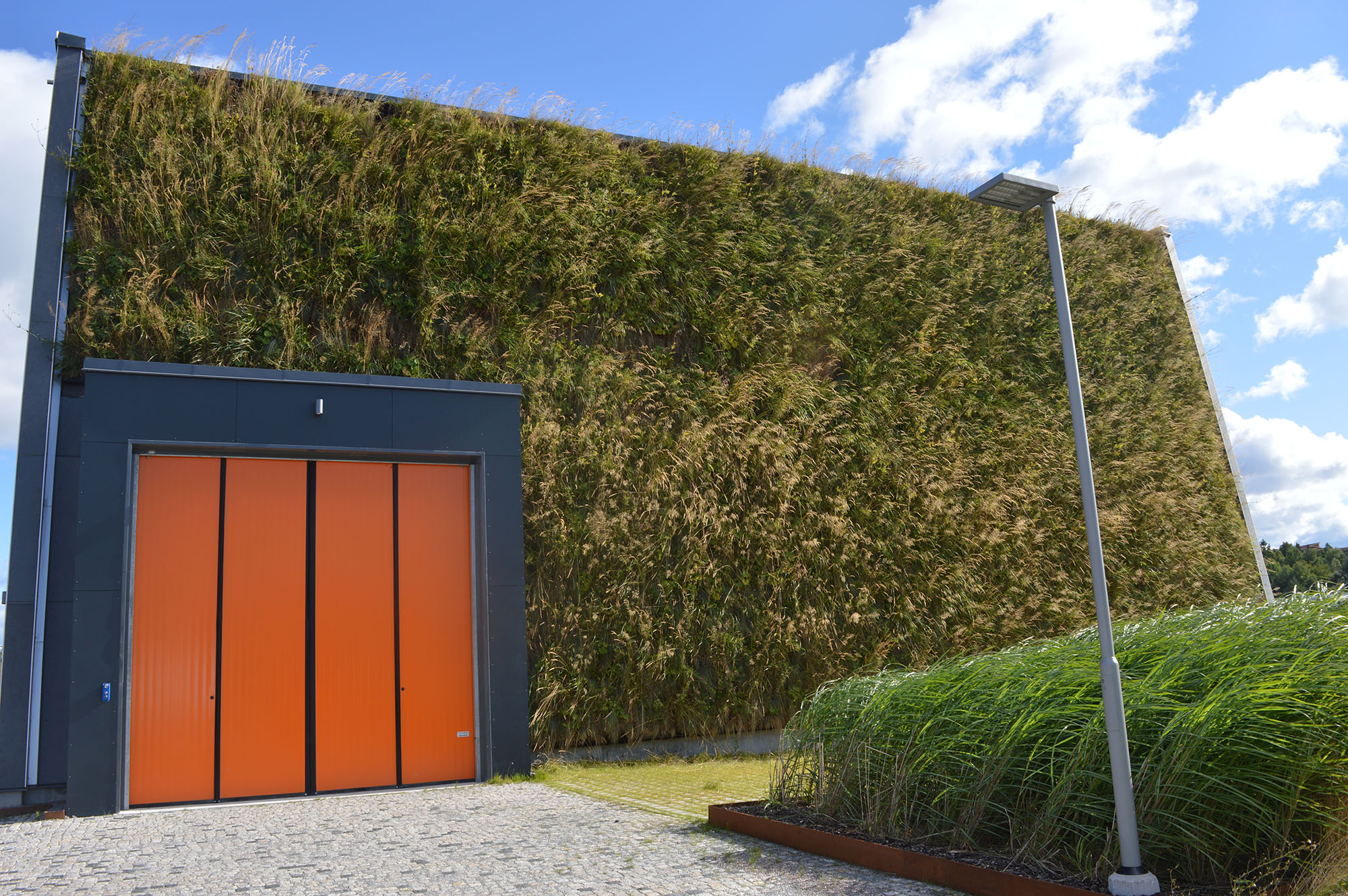 Ursvik Recycling Centre exterior, covered in a living wall
