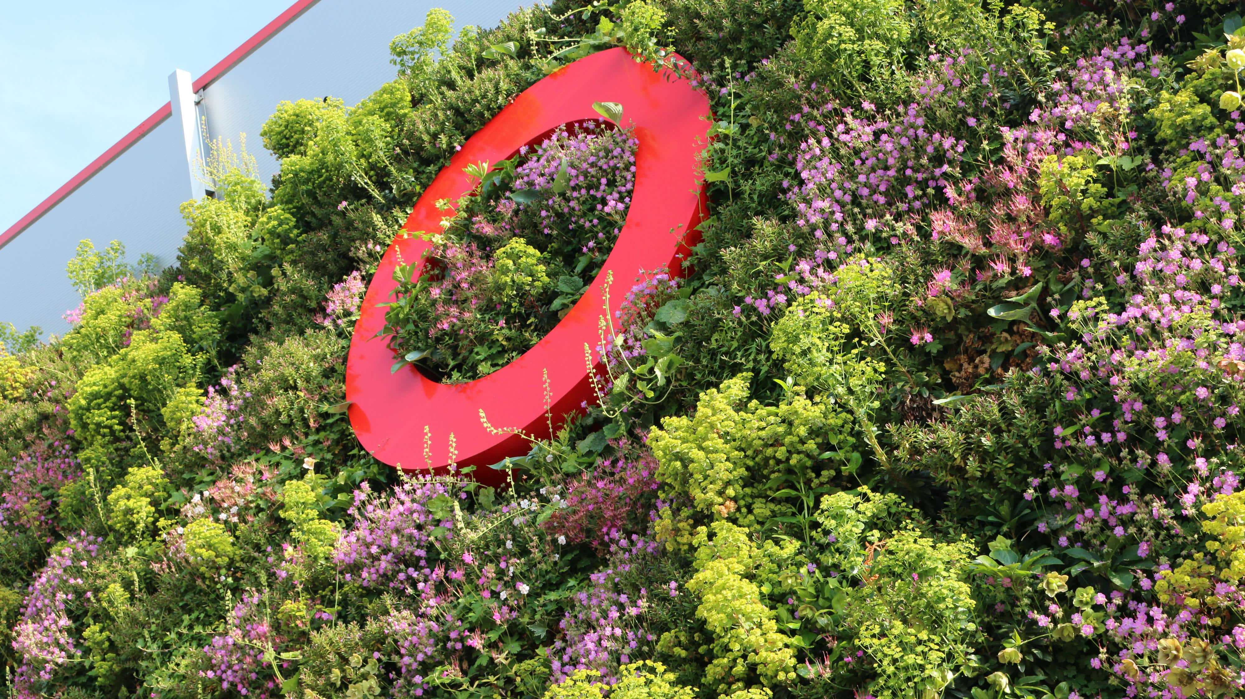 Living wall on the Equinix Data Centre FR10 in Frankfurt, Germany with a cherry picker building the living wall