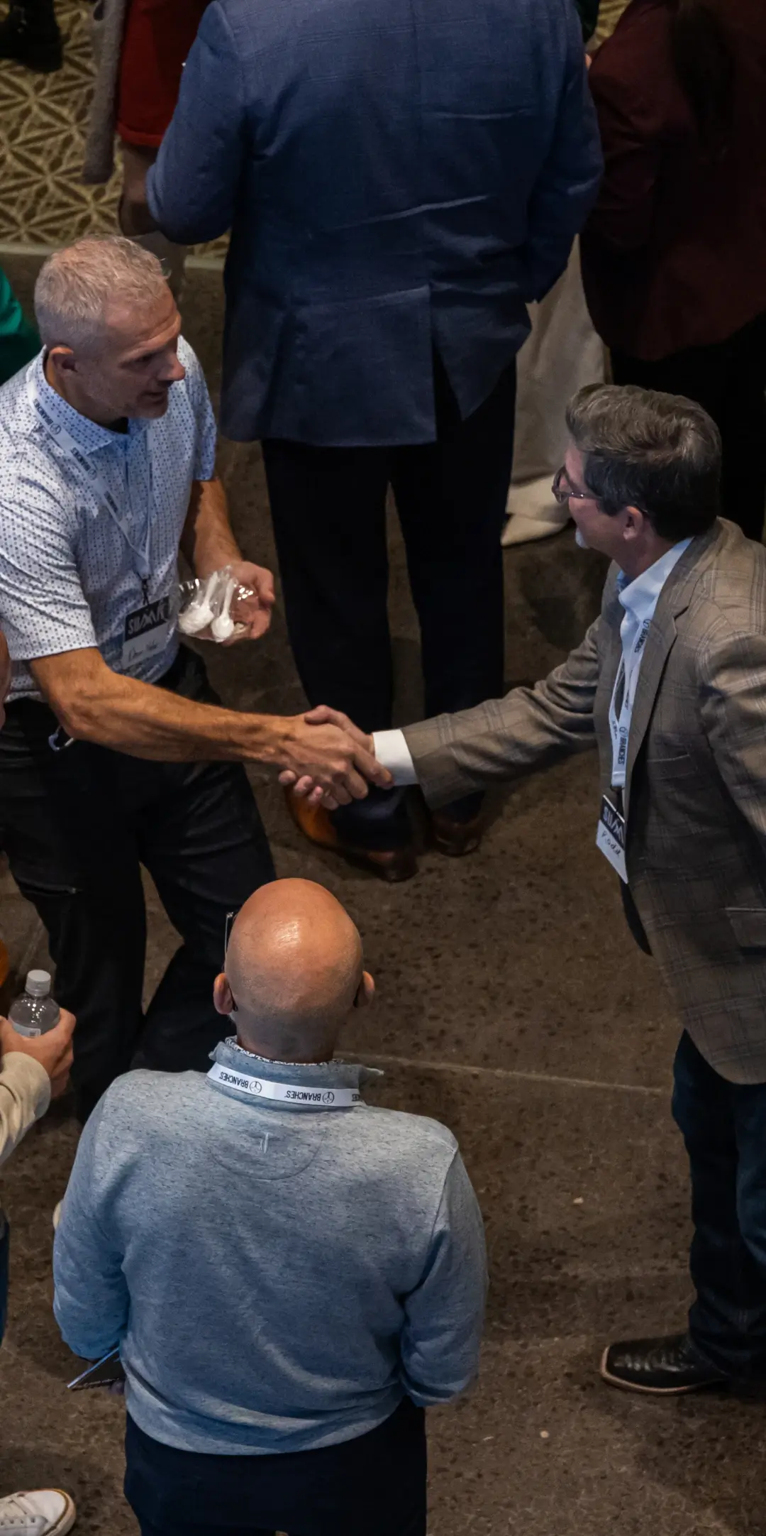 two men reaching out and shaking hands