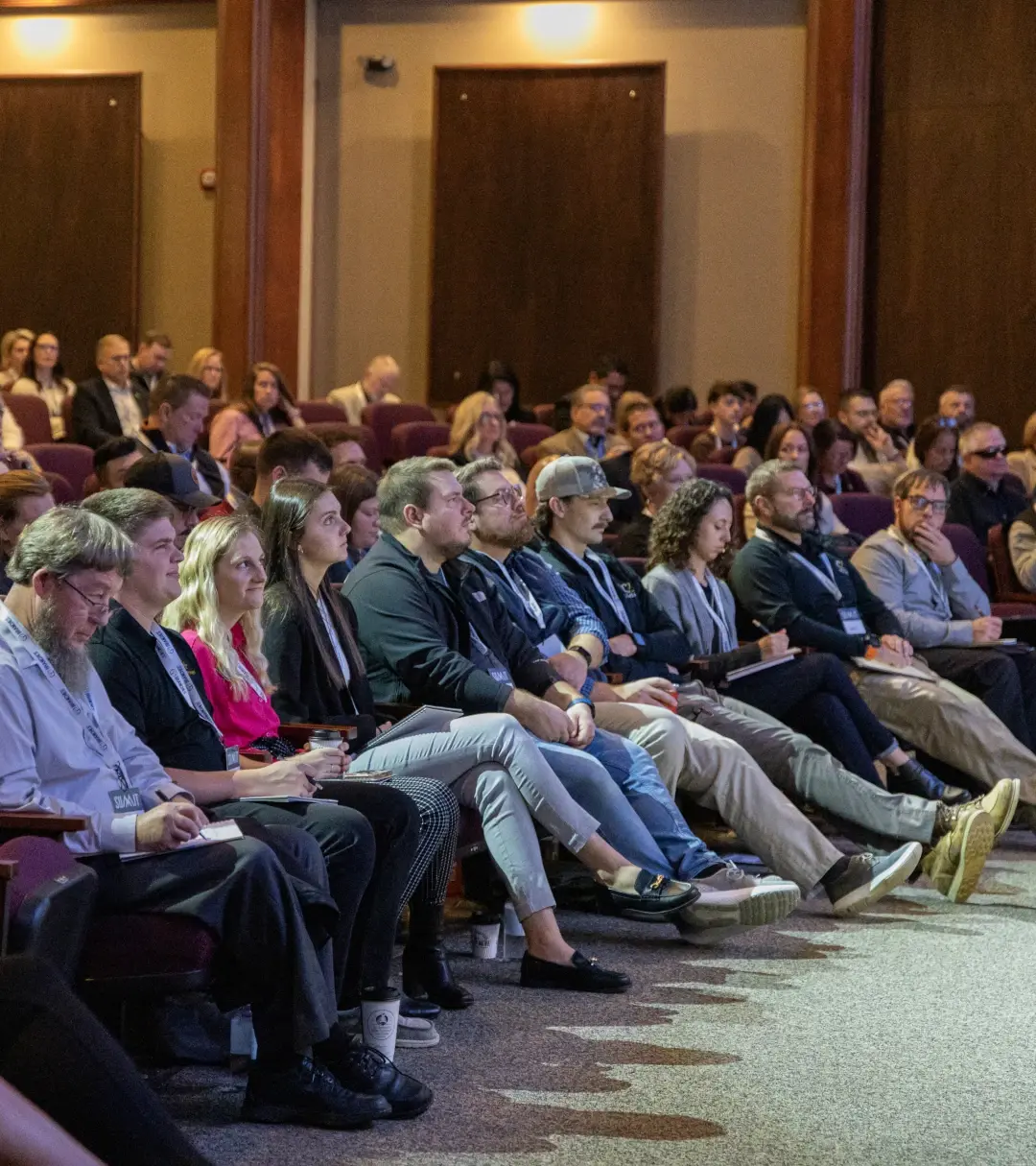 group of attentive crowd members looking toward stage