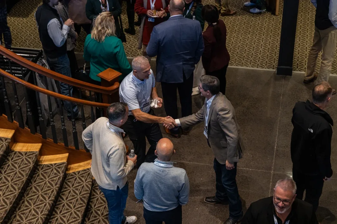 attendees shaking hands and networking at branches summit