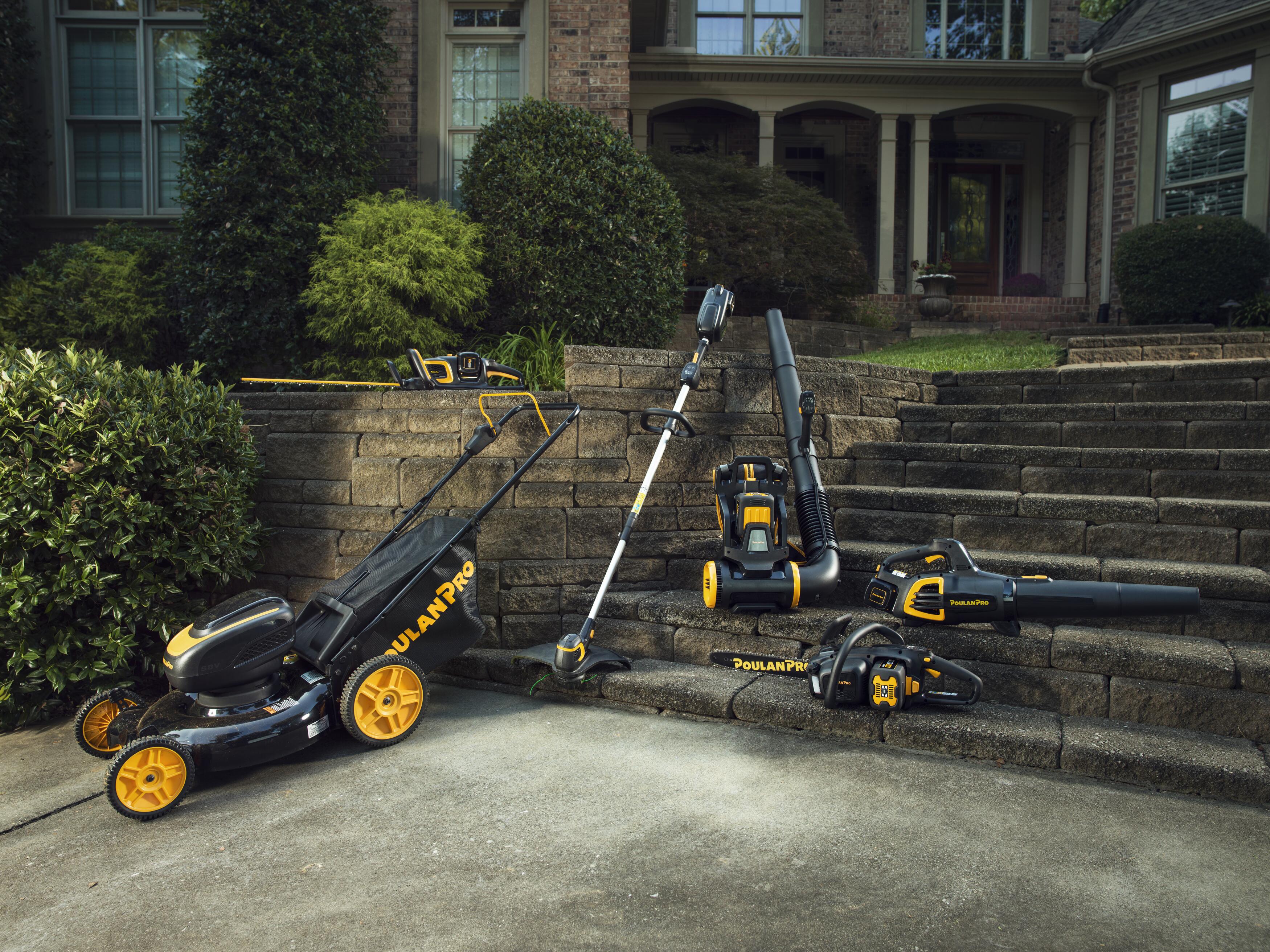 an Pro outdoor power equipment collection displayed on stone steps in front of a house.