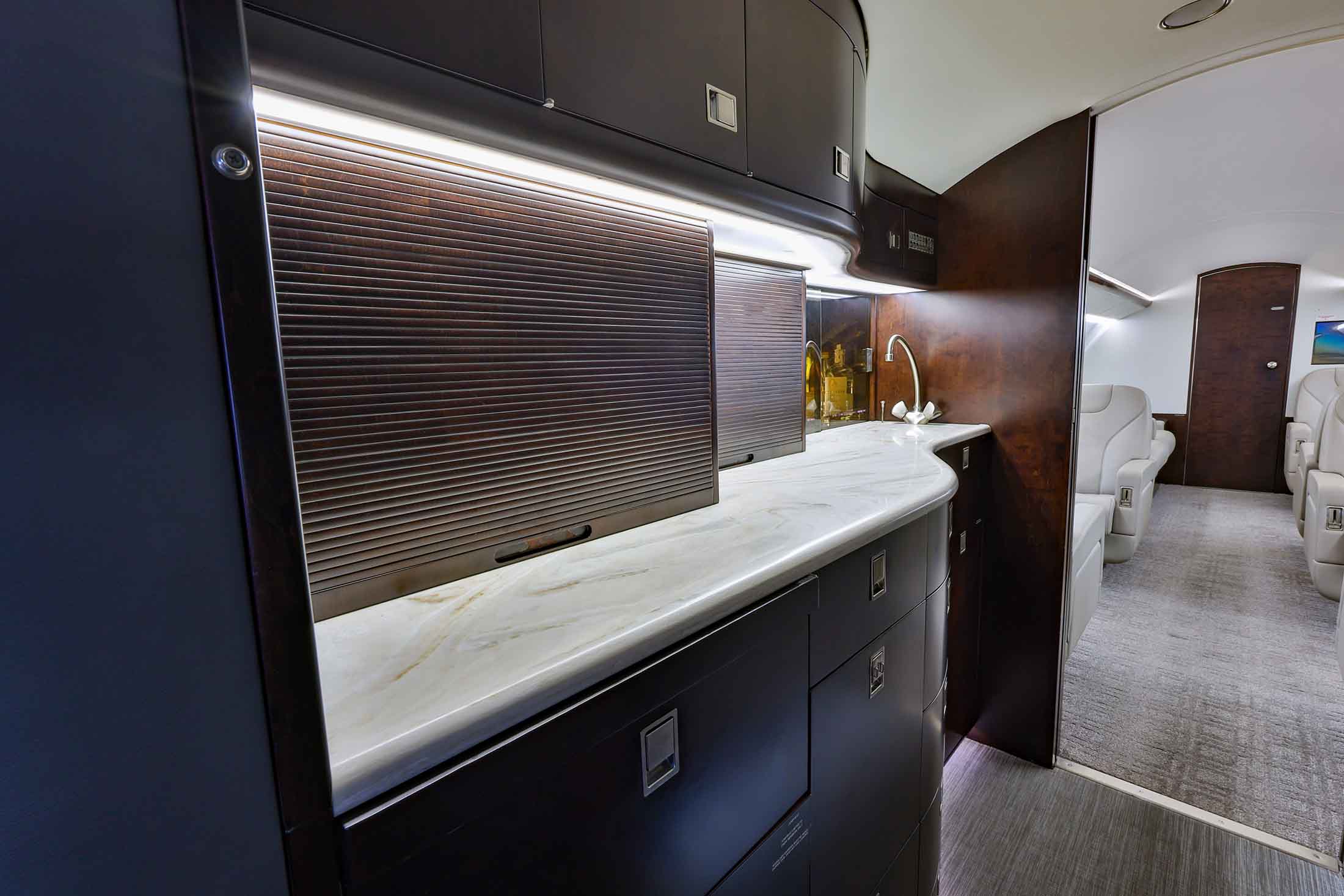 The main cabin of the Falcon 2000LX through the forward galley toward the cockpit