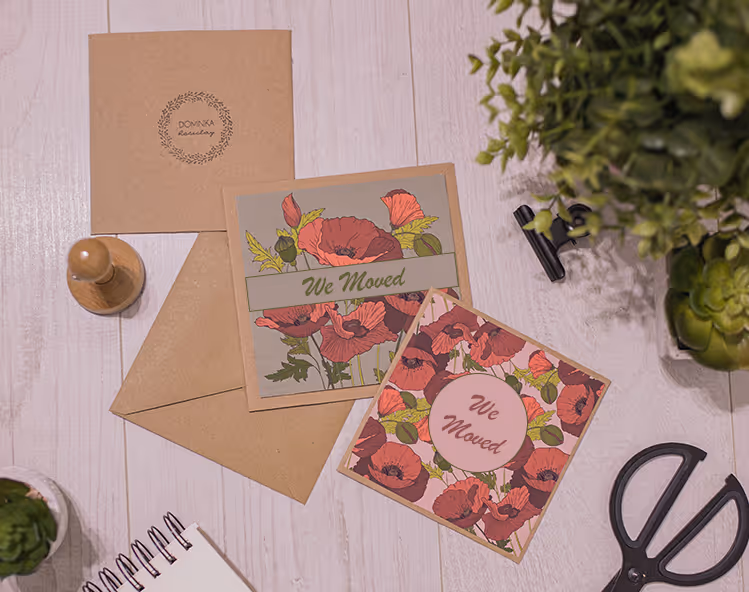 Cards laying on a table that says "we moved."