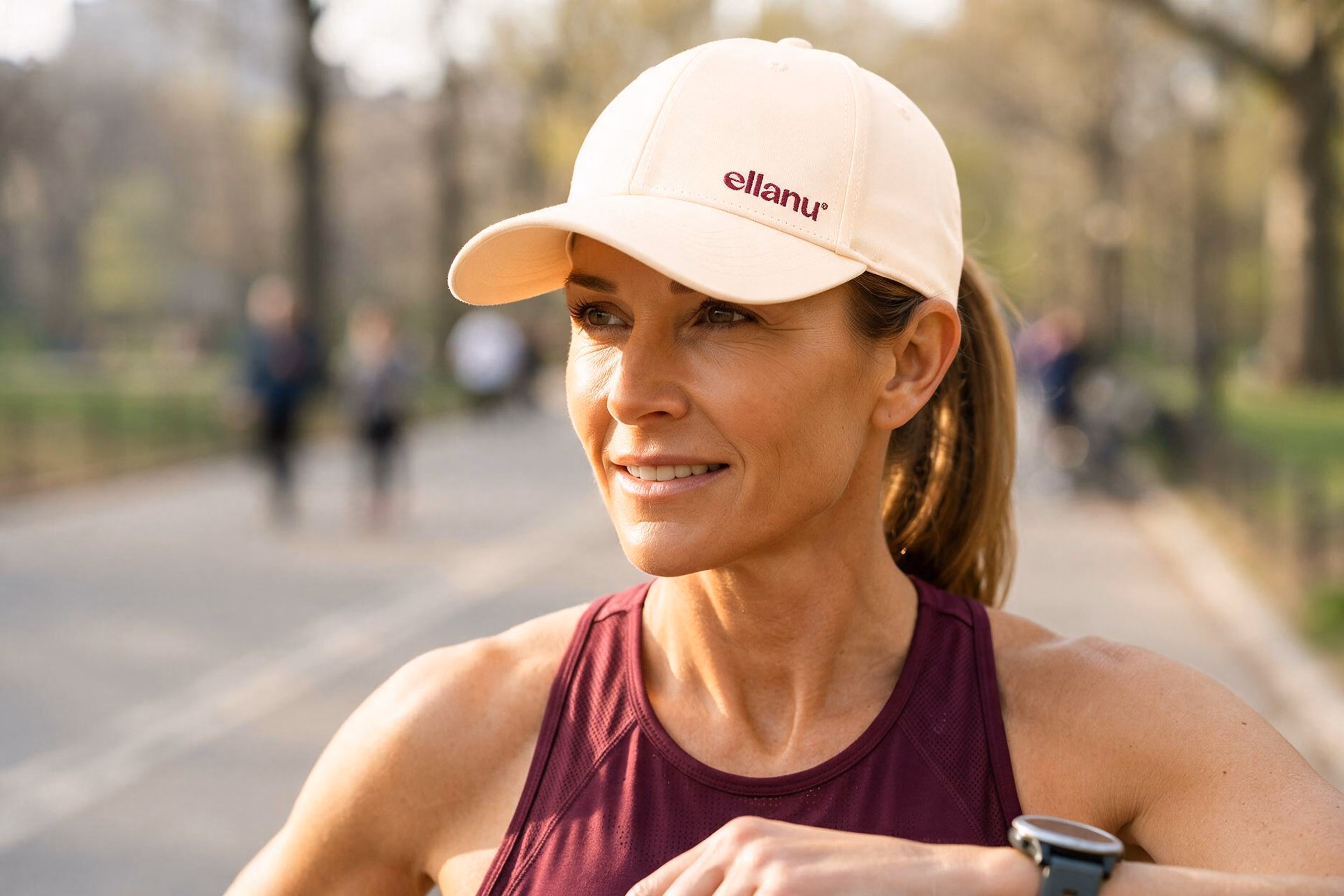 Woman outdoors wearing an EllaNu embroidered cream cap.