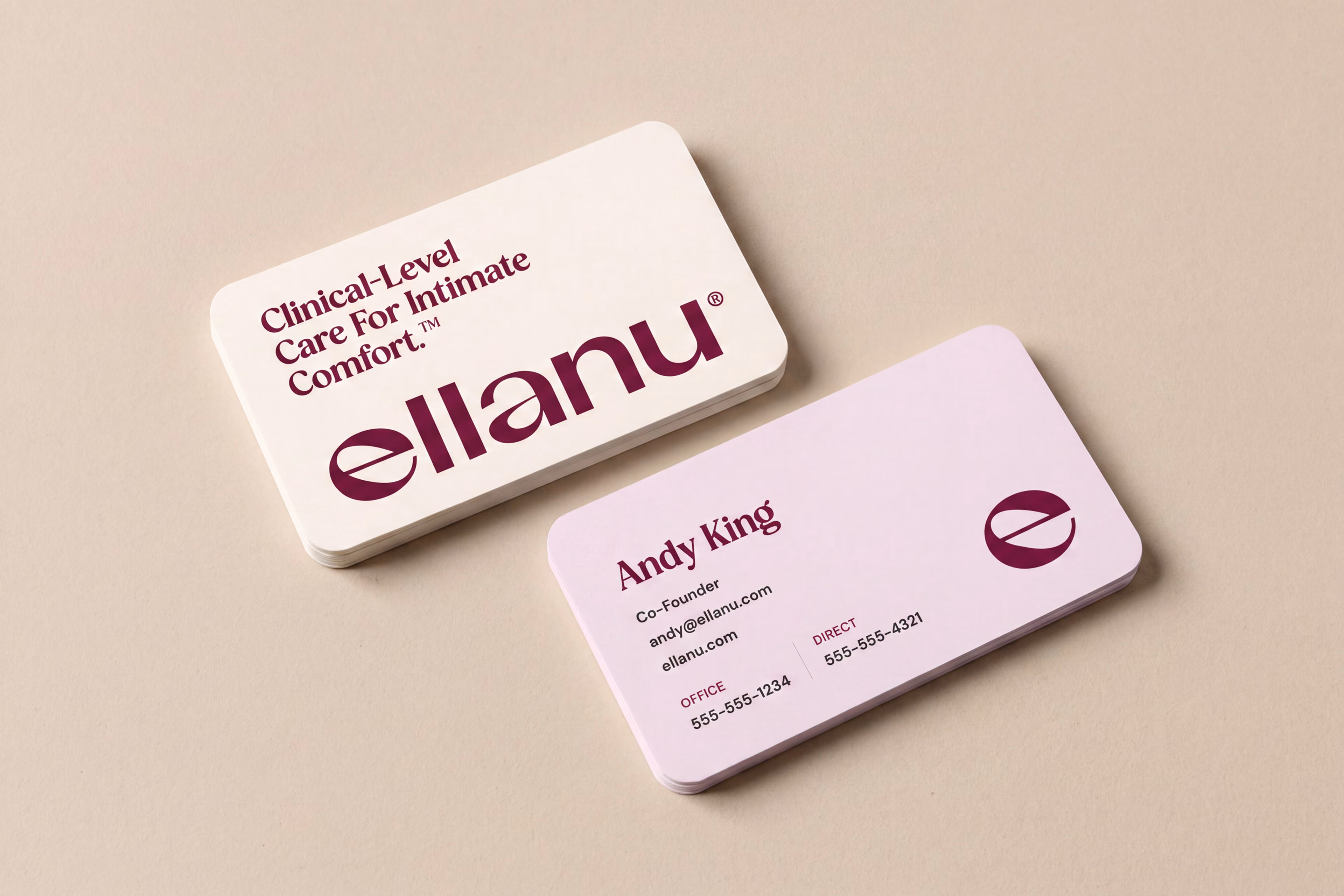 EllaNu business cards with burgundy branding on cream and pink.