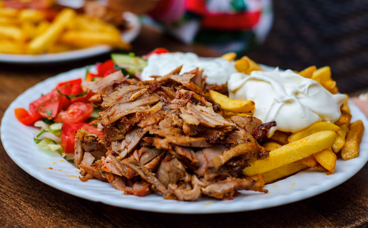 Shawarma meat with salads, french fries and yougurt dressing