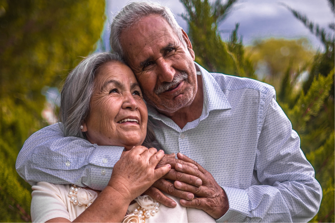 An older couple embraces