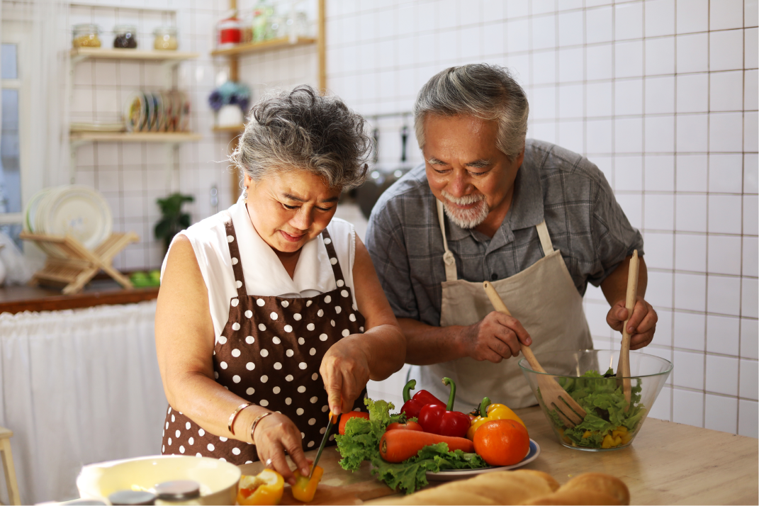 An older couple cooking in a modern kitchen