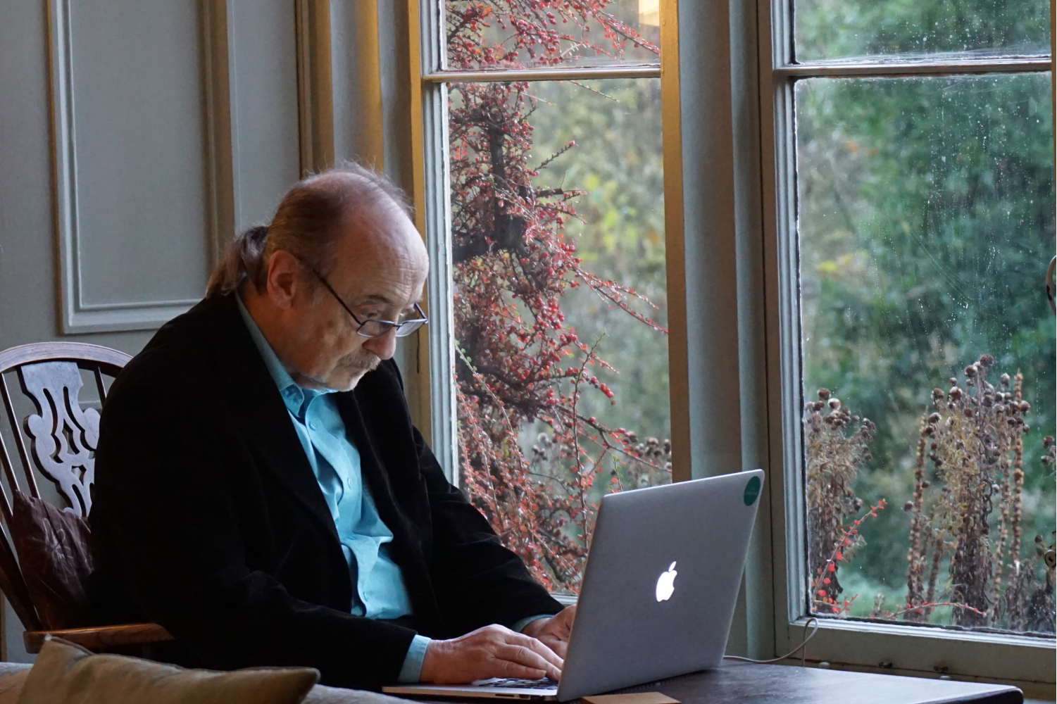 An older man using a personal computer